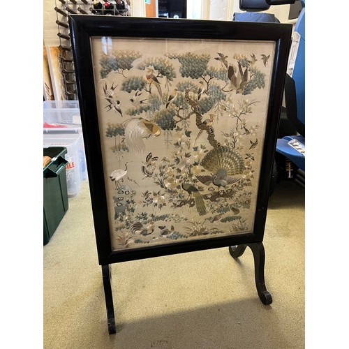 447 - A Chinese embroidered picture depicting peacocks and cranes, fitted into a fire screen. On inspectio... 