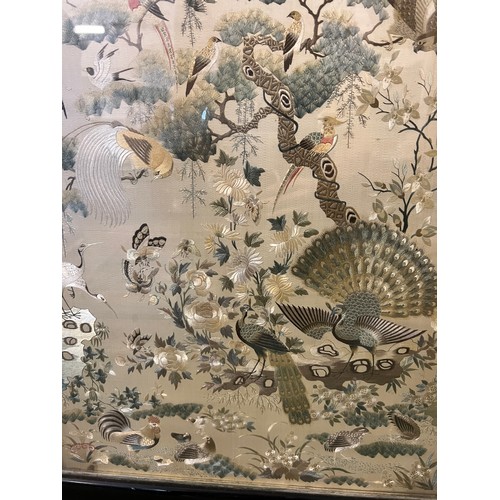 447 - A Chinese embroidered picture depicting peacocks and cranes, fitted into a fire screen. On inspectio... 