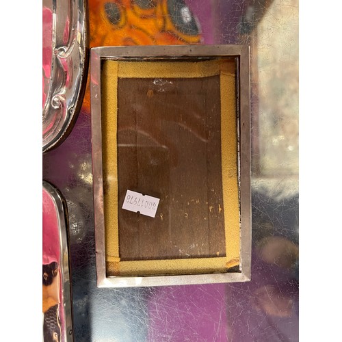 26 - Two Silver Photograph Frames with scrolling decoration & Plain along with one other Silver square.