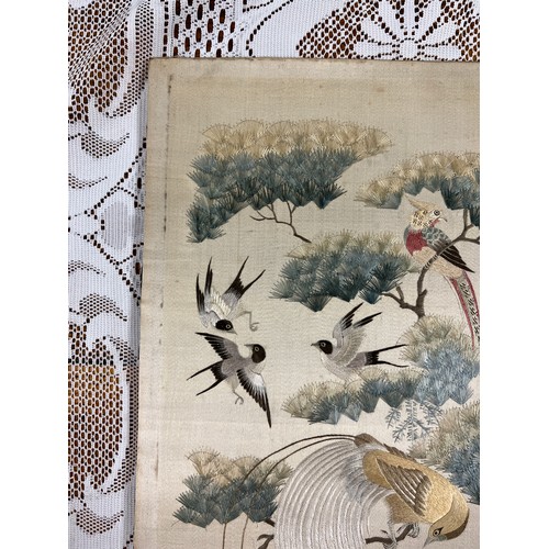 447 - A Chinese embroidered picture depicting peacocks and cranes, fitted into a fire screen. On inspectio... 