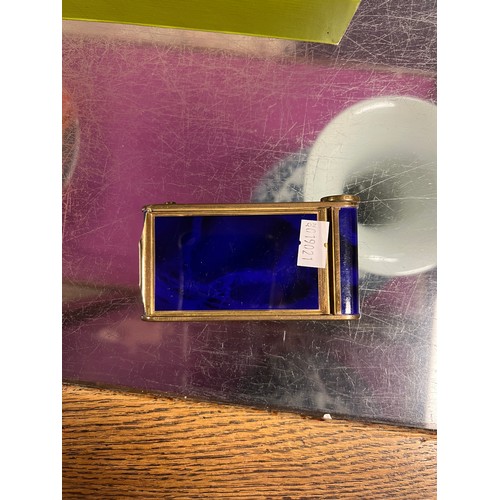 744 - A 1920s/30s blue enamelled compact with necessaire, opera glasses and packs of playing cards, a glas... 