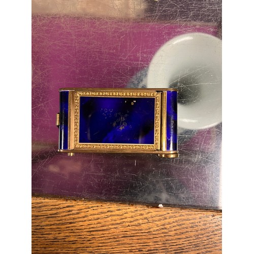 744 - A 1920s/30s blue enamelled compact with necessaire, opera glasses and packs of playing cards, a glas... 