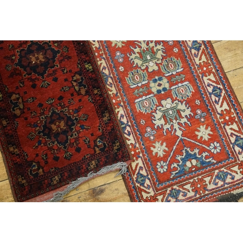 287 - Two Red Runners. Measuring: 203cms long x 66cms across. (Large One). 150cms Long x 59cms across. (Sm... 