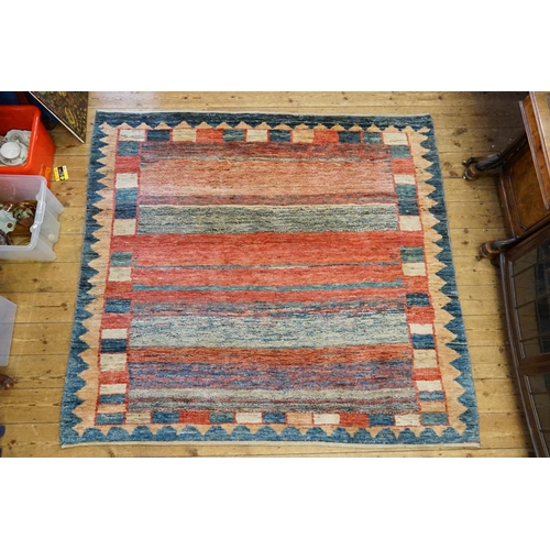 289 - A Modern Berber Hook and Twist Multi Coloured red, blue and beige floral bordered Rug. Measuring: 19... 