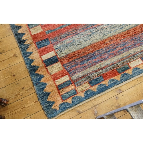 289 - A Modern Berber Hook and Twist Multi Coloured red, blue and beige floral bordered Rug. Measuring: 19... 