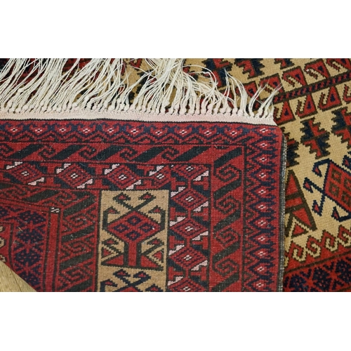 292 - A Red Ground Prayer Rug with a Twin Geometric design, Central Fish Scale pattern, cream and blue dia... 