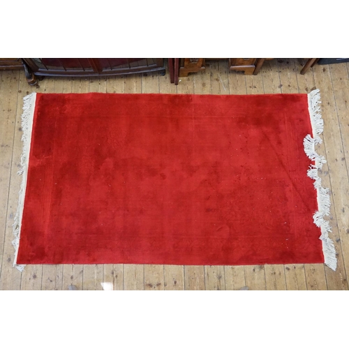 294 - A Red Ground Chinese Carpet with slight moth damage. Measuring: 275cms x 152cms