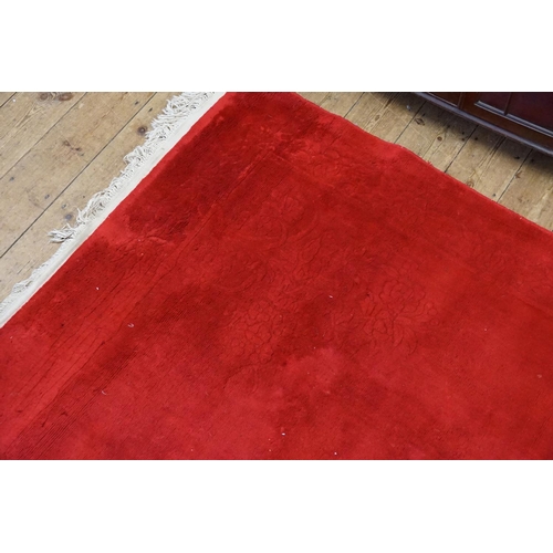 294 - A Red Ground Chinese Carpet with slight moth damage. Measuring: 275cms x 152cms