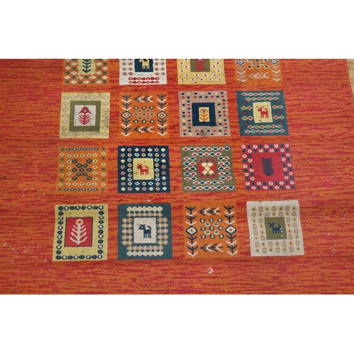 296 - A Turkish Red ground, square gul, fishtail design carpet with fringed edge. Measuring: