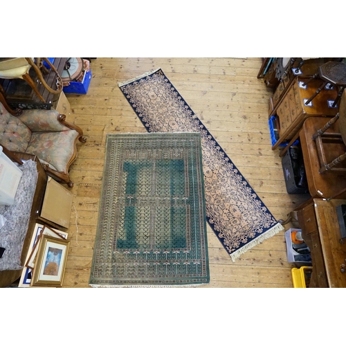 298 - A Green Floral bordered Quadruple Gul and Cross patterned Rug. Measuring: 122cms x 185cms. Along wit... 