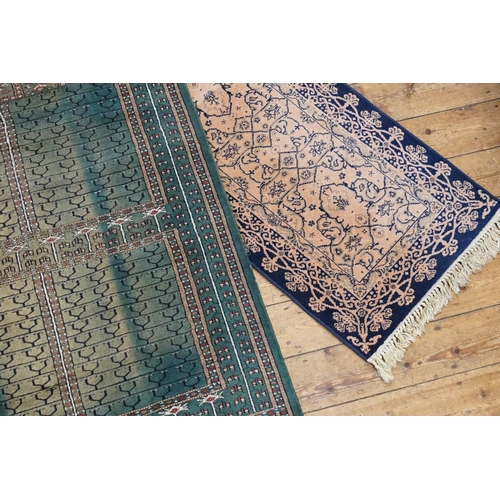 298 - A Green Floral bordered Quadruple Gul and Cross patterned Rug. Measuring: 122cms x 185cms. Along wit... 