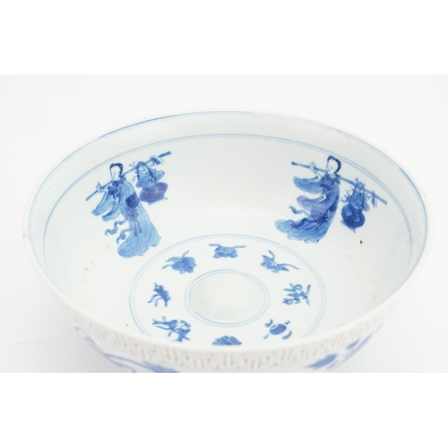 411 - A Japanese key bordered bowl with figures holding a vase of flowers.