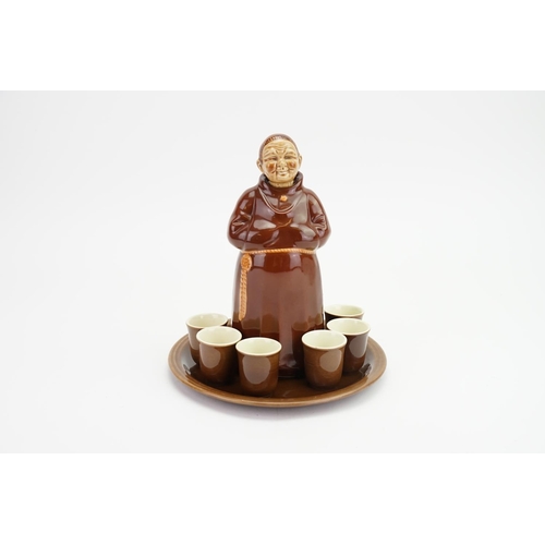 958 - A German made Tippley Monk Decanter along with six top glasses.