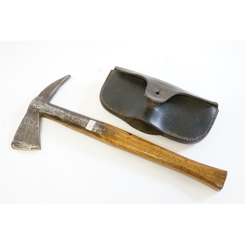 382 - A First World War Pioneer's elm handled pick contained in a period leather case.