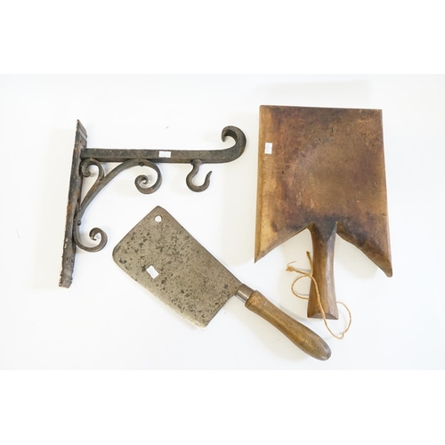 369 - A Victorian wrought iron bell bracket, a large chopper and a Rustic bread board.