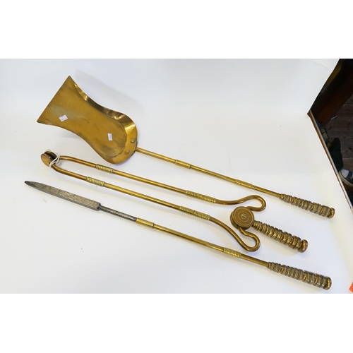 376 - A Three Piece Brass Fireside Companion set consisting of tongs, a poker and an Acorn Shovel.