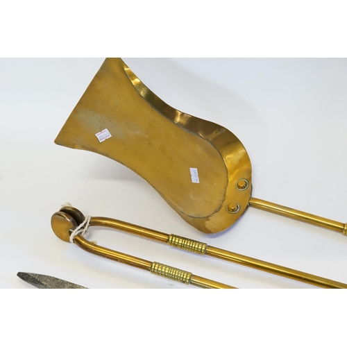 376 - A Three Piece Brass Fireside Companion set consisting of tongs, a poker and an Acorn Shovel.