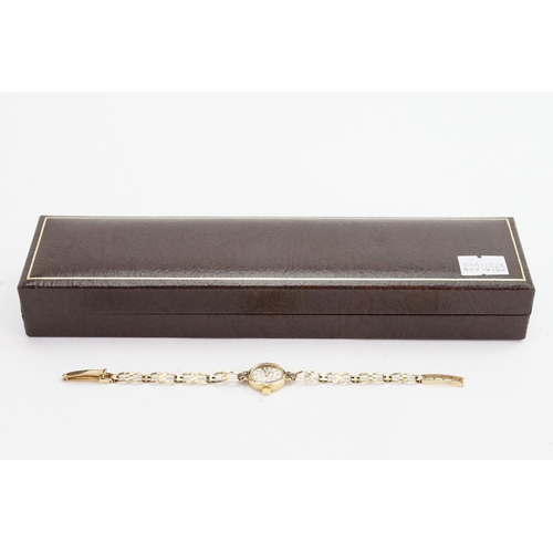 233 - A 9ct Gold Ladies Cocktail Wristwatch with a 9ct Gold strap. Total weight approximately: 8.6 grams.