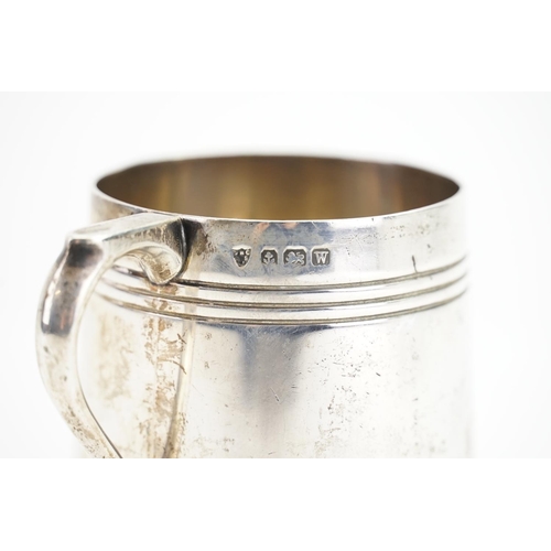 63 - A Child's Silver Can with ribbed decoration. Weighing: 154 grams.