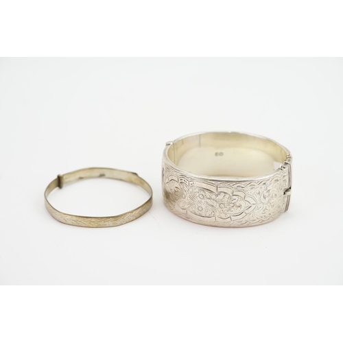 108 - A Silver Bangle with engraved decoration & one other.