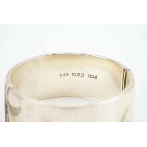 108 - A Silver Bangle with engraved decoration & one other.