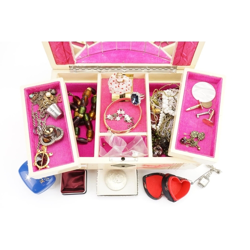 190 - A Musical Jewellery Box containing Costume Jewellery, Necklaces, etc.