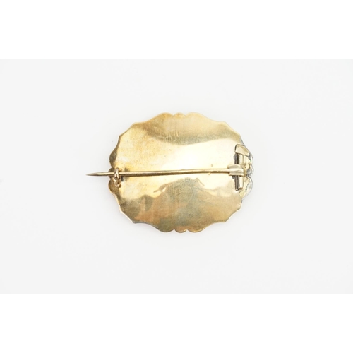 149 - A Gold and Onyx set mourning brooch, pearl set. Weighing: 9.4gms.