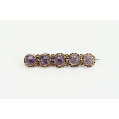 181 - A Ladies 12ct Gold Amethyst Brooch mounted in a Filigree Style Mount.