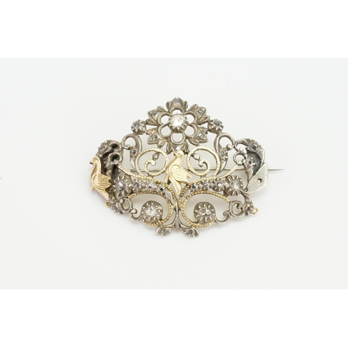 186 - An Indian Silver Diamond Set & Gold Mounted Brooch designed with Birds, Floral Scrolls, etc.