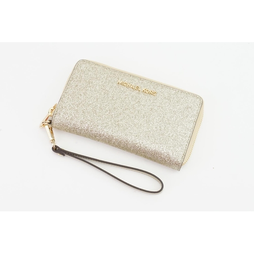 318 - A Michael Kors Large Cross Grain Leather Smartphone Wristlet. Measuring: 19cms x 10cms.