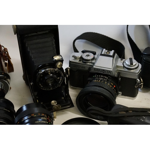 343 - A large collection of camera equipment including Holiday II, Minolta XGM, EXA, Konica and various le... 