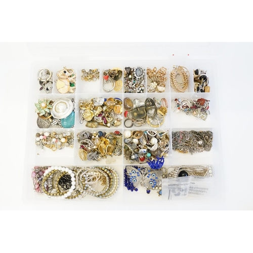 214 - A Plastic container with a quantity of chains, badges, beads and other small items.