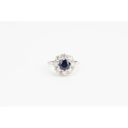 92 - A 18ct White Gold Diamond and Sapphire set Floral Ring, set with a 1ct Sapphire & 8 0.10ct Diamonds.... 