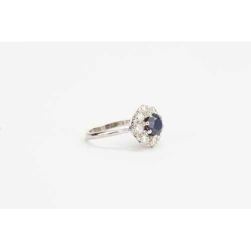 92 - A 18ct White Gold Diamond and Sapphire set Floral Ring, set with a 1ct Sapphire & 8 0.10ct Diamonds.... 