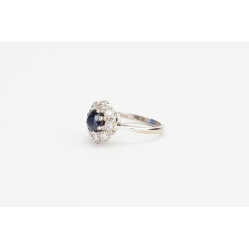 92 - A 18ct White Gold Diamond and Sapphire set Floral Ring, set with a 1ct Sapphire & 8 0.10ct Diamonds.... 