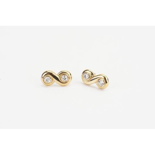 71 - A Pair of Yellow Gold Eternity style Earrings set with two Diamonds in each (0.15ct each). Measuring... 