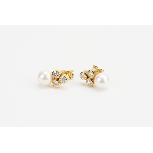 75 - A Pair of 18ct Gold Three Stone Diamond (0.1ct each) and Pearl Earrings in the drop design. Weighing... 