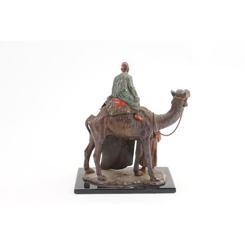 256 - A Spelter Table Lighter designed as a Camel with Attendants.