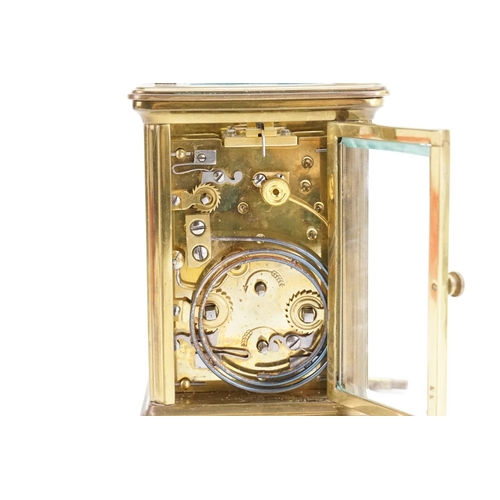 223 - A Brass Four Plate French Design Carriage Clock with alarm & Chiming Movement with a White enamelled... 