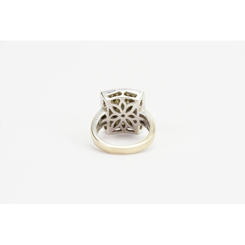 161 - An 18ct Gold Diamond Ring in a Square Setting. Size N. Weight: 9.7 grams.