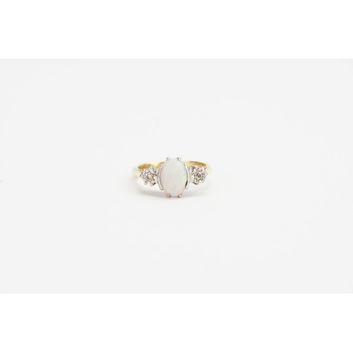 84 - A 18ct Gold & Platinum set Diamond and Opal Ring. Diamond size: 0.05ct each. Opal size: 1ct. Ring Si... 