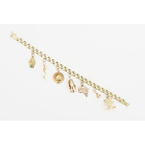 180 - A 14ct Gold Charm Bracelet to include an 18ct Gold Charm, 10ct Hat Charm and various other Charms. W... 