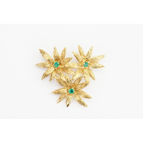 103 - An 18ct Yellow Gold Emerald Set Flower Brooch set with 3 Emeralds. (0.05ct). Weight: 8.7 grams. Size... 