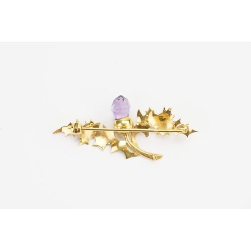 121 - A 9ct Gold Thistle Brooch set with an Acorn shaped Amethyst and safety chain. Weight: 3.7 grams.