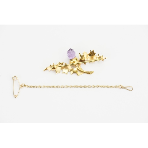 121 - A 9ct Gold Thistle Brooch set with an Acorn shaped Amethyst and safety chain. Weight: 3.7 grams.