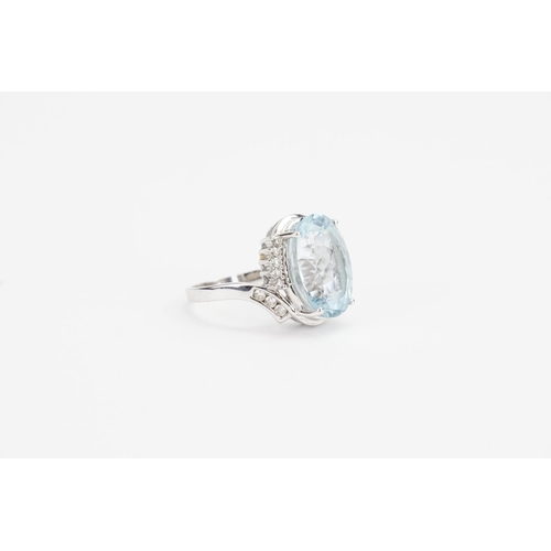 138 - A 14ct White Gold and Diamond set Aquamarine Ring cut in an Oval shape, set with 16 Diamonds. Aquama... 