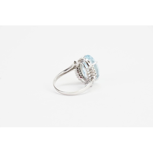 138 - A 14ct White Gold and Diamond set Aquamarine Ring cut in an Oval shape, set with 16 Diamonds. Aquama... 