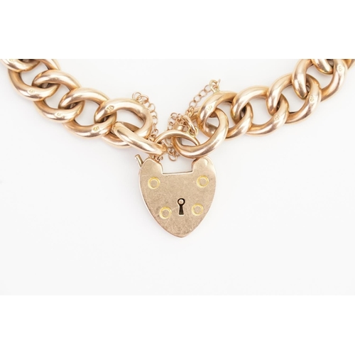 105 - A 15ct Gold (marked) Padlock Bracelet hung with a Love Heart Locket. Weight: 27.1 grams.