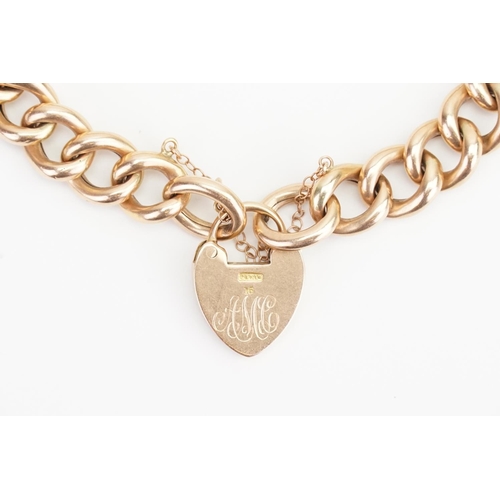 105 - A 15ct Gold (marked) Padlock Bracelet hung with a Love Heart Locket. Weight: 27.1 grams.