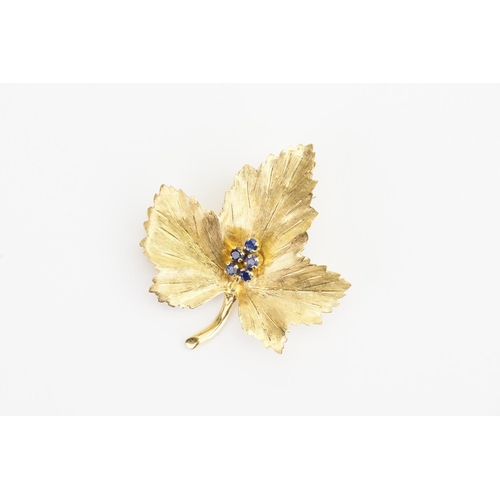 117 - A 18ct Gold Leaf design Brooch set with 5 Small Sapphires. Weight: 7.1 grams. Size: 4cms x 3.5cms.